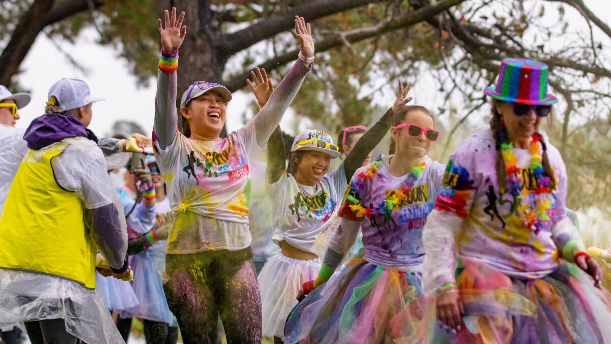 The Colour Frenzy run held at Weston Park went ahead on Sunday regardless of the weather. Picture: Sitthixay Ditthavong