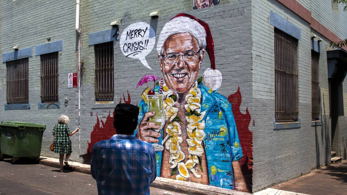 A mural by artist Scott Marsh depicting Prime Minister Scott Morrison on holiday in Hawaii during the Black Summer bushfires. Picture: Getty Images