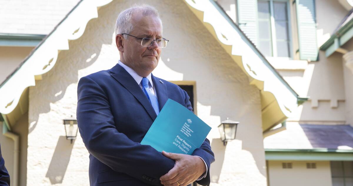 Prime Minister Scott Morrison with the aged care report. Picture: Getty Images