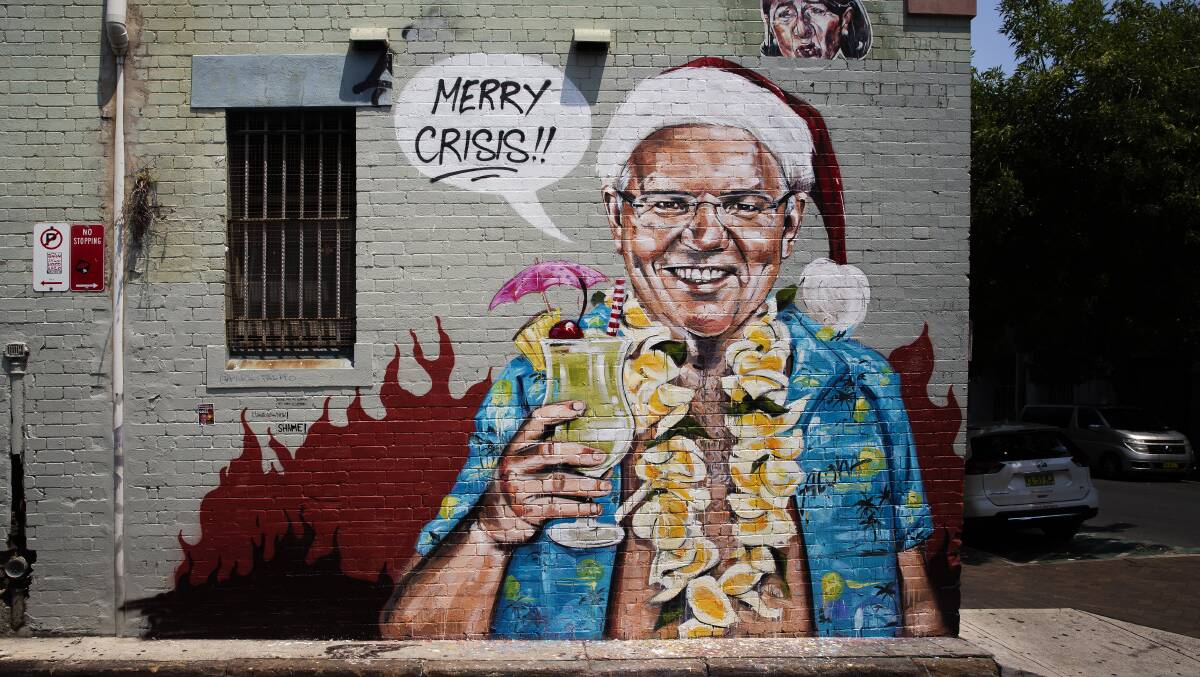A mural in Sydney by artist Scott Marsh depicting Prime Minister Scott Morrison on holiday in Hawaii during the Black Summer bushfires. Picture: Getty Images