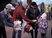 Volunteers from the United Kingdom give away soft toys to refugees fleeing Ukraine as they arrive in Hungary. Picture: Getty Images