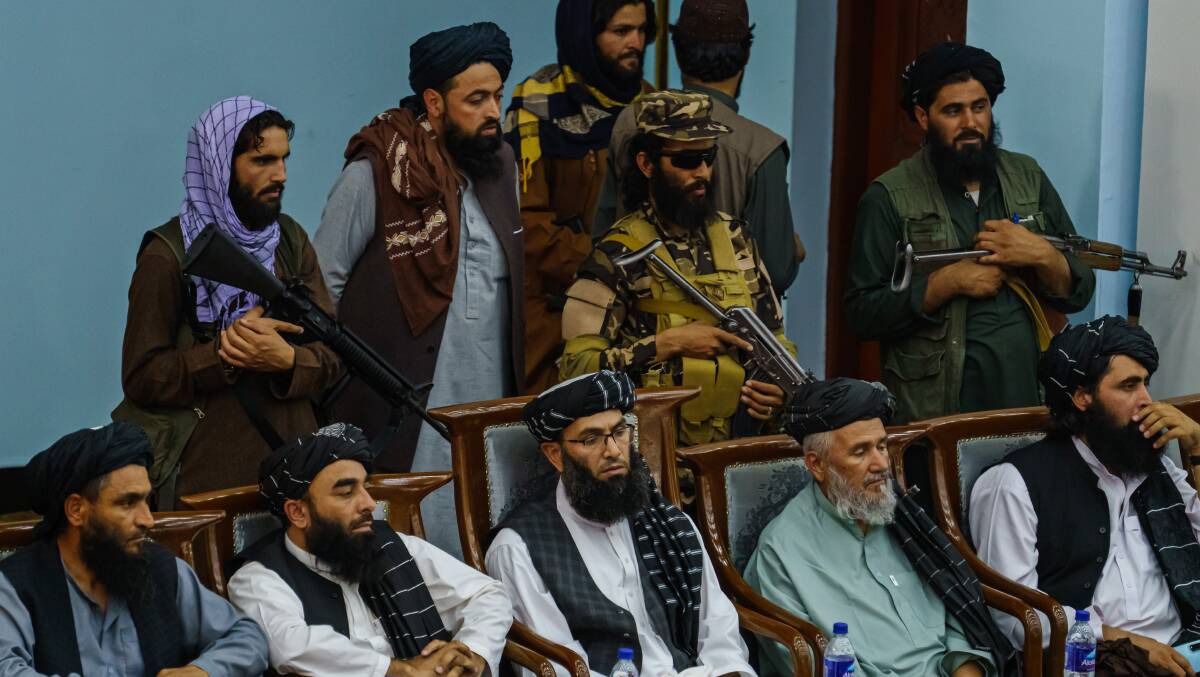 Zabihullah Mujahid, second from bottom left, joins others as hundreds of religious leaders attend the Taliban's preaching and guidance commission in Kabul on Monday. Picture: Getty Images