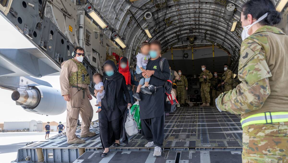 A family of evacuees from Kabul, Afghanistan arrive at Australia's main operating base in the Middle East on an RAAF C-17A Globemaster. The government has promised to take in just 3000 Afghan refugees. Picture: Department of Defence