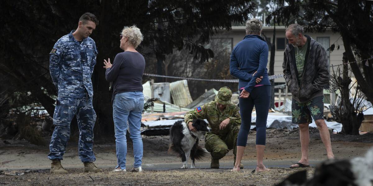 ADF personnel chat with bushfire-affected residents in Mallacoota, Victoria. Picture: Department of Defence