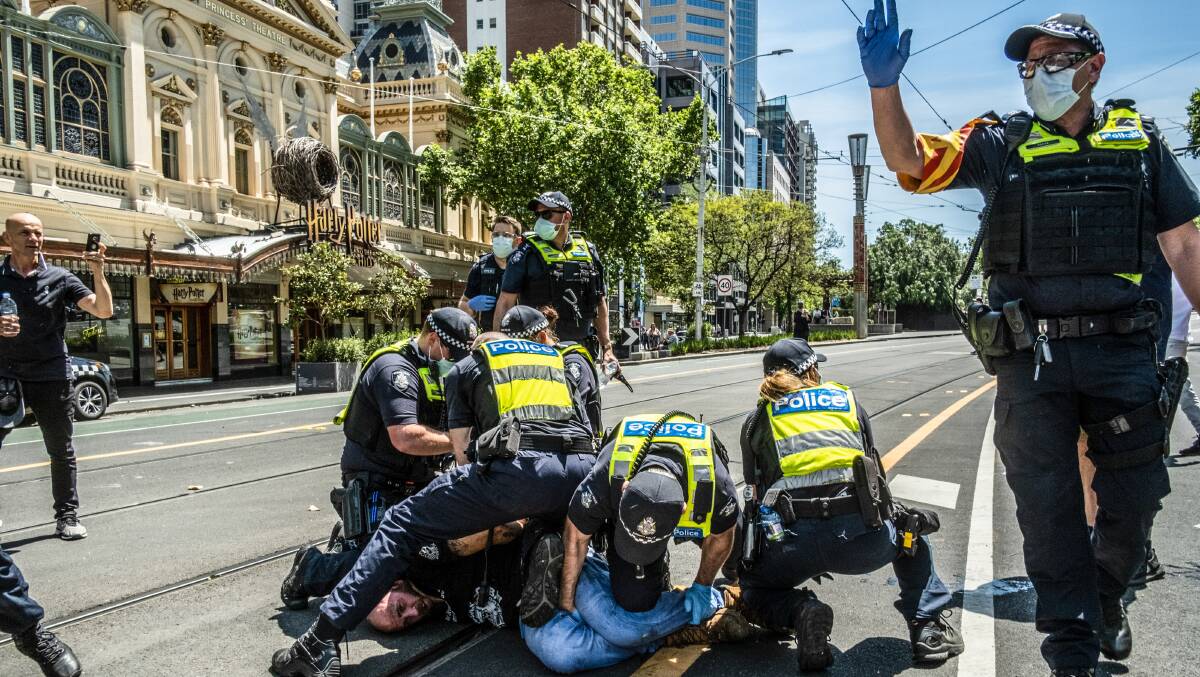 A member of the Proud Boys is arrested by Victorian police during a demonstration at Parliament House in Melbourne. Picture: Getty Images