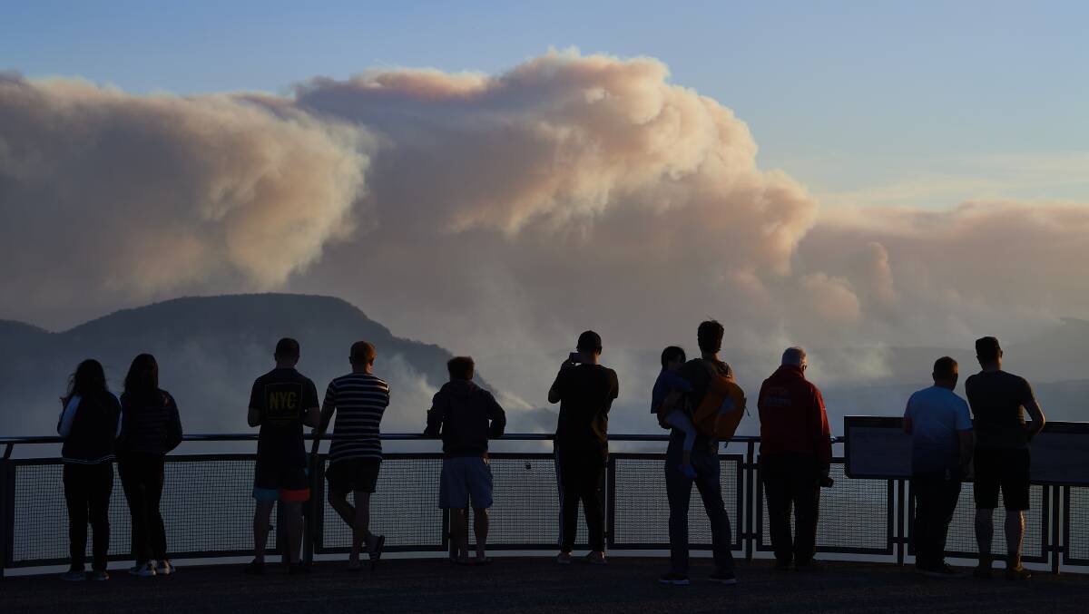 People view smoke from scattered bushfires on a lookout platform in the Blue Mountains. It's estimated about 20 per cent of the Blue Mountains World Heritage Area has been impacted. Picture: Getty Images