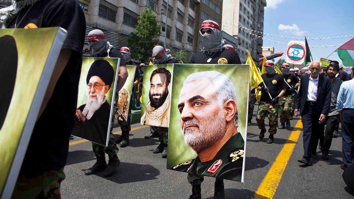 A marcher carries a poster of Major-General Qasem Soleimani at last year's Quds Day rally in Tehran. Picture: Shutterstock