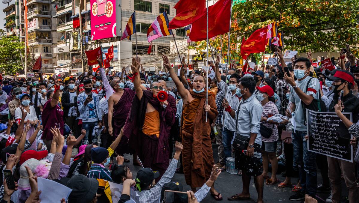Buddhist monks give the three-fingered salute at a pro-democracy protest in Yangon. Picture: Getty Images