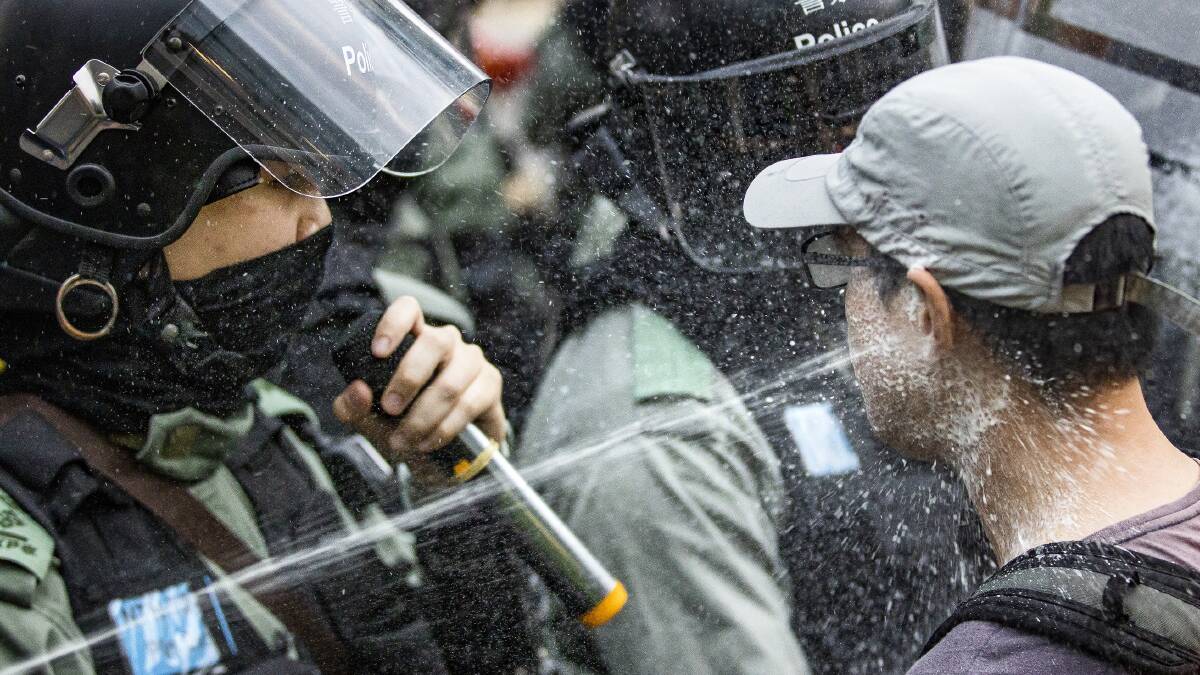 Police pepper spray a protester in Sheung Shui, Hong Kong, in January. Picture: Sitthixay Ditthavong