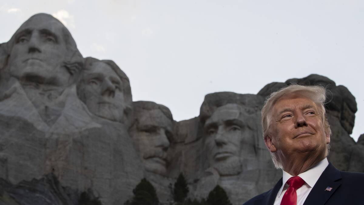 President Donald Trump smiles at Mount Rushmore on Friday, July 3, near Keystone, South Dakota. Picture: AP Photo/Alex Brandon