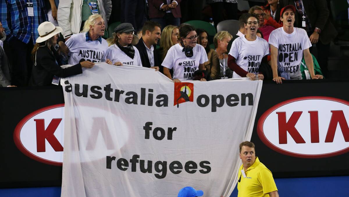 Protesters at the Australian Open in 2015 unfurl a banner calling attention to the Manus Island detention centre. Picture: Getty Images