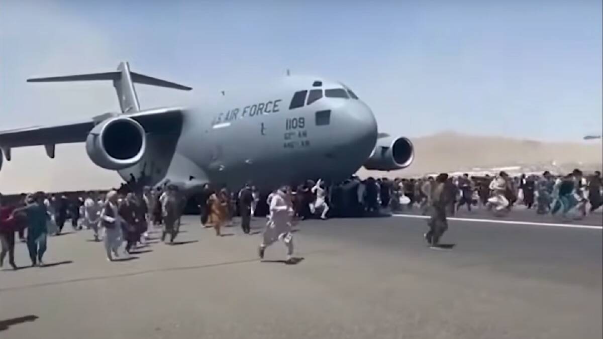 Afghans cling to a US C-17 Globemaster taking off from Kabul's airport in August amid the Taliban takeover. Video screengrab: TOLOnews