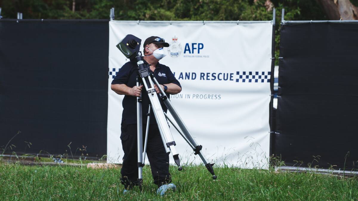 A police officer sets up a panoramic camera at the scene. Picture: Dion Georgopoulos