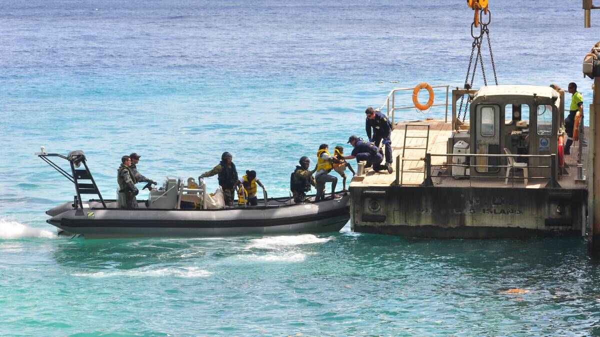 Asylum seekers arrive at Christmas Island after being intercepted by the Royal Australian Navy in August 2013. Picture: Getty Images