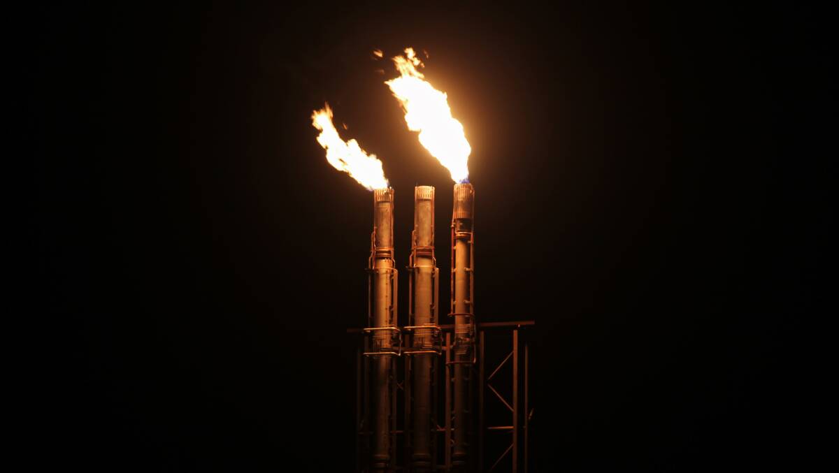 A gas plant flare stack burning at night. Picture: Shutterstock