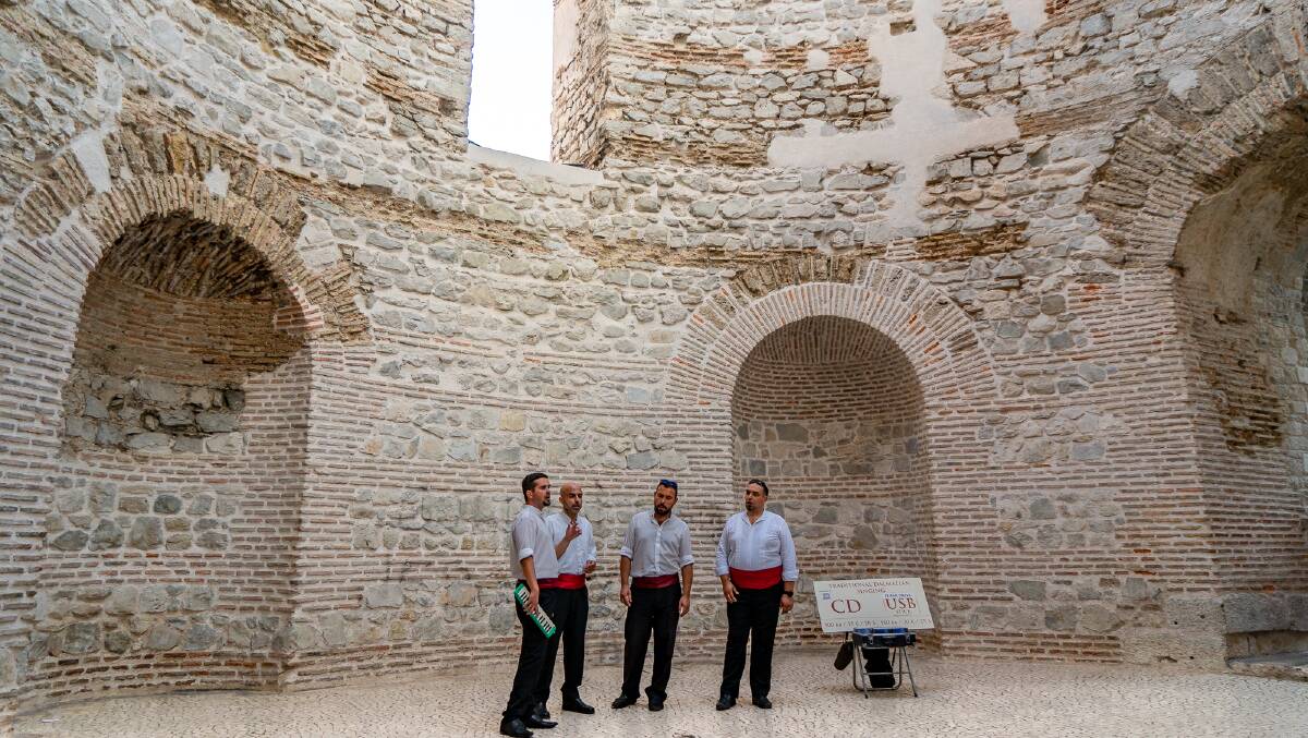 A small choir performs in the ancient circular meeting hall known as the Vestibule.