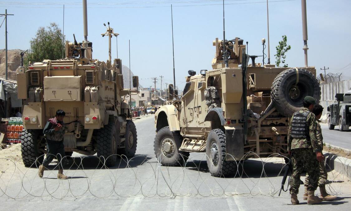 Afghan soldiers secure the road outside Kandahar Prison following the mass escape by inmates, on April 25, 2011 in Kandahar, Afghanistan. Picture: Getty Images