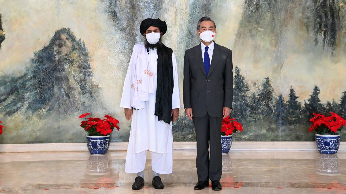 Taliban political chief Mullah Abdul Ghani Baradar (left) meets with Chinese Foreign Minister Yi Wang in Tianjin on July 28. Picture: Getty Images