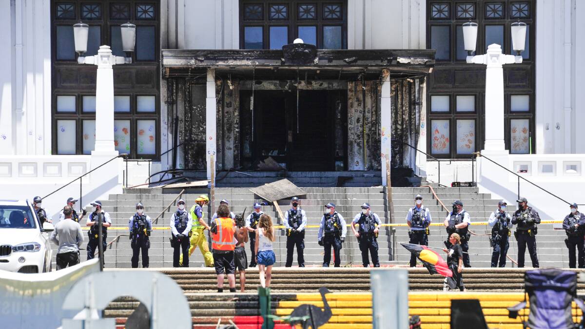Protesters remained at the scene the day after the historic portico at Old Parliament House was damaged by fire. Picture: Dion Georgopoulos