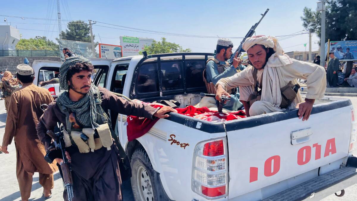 Members of the Taliban arrive near Hamid Karzai International Airport as thousands of civiliants attempt to escape the capital. Picture: Getty Images