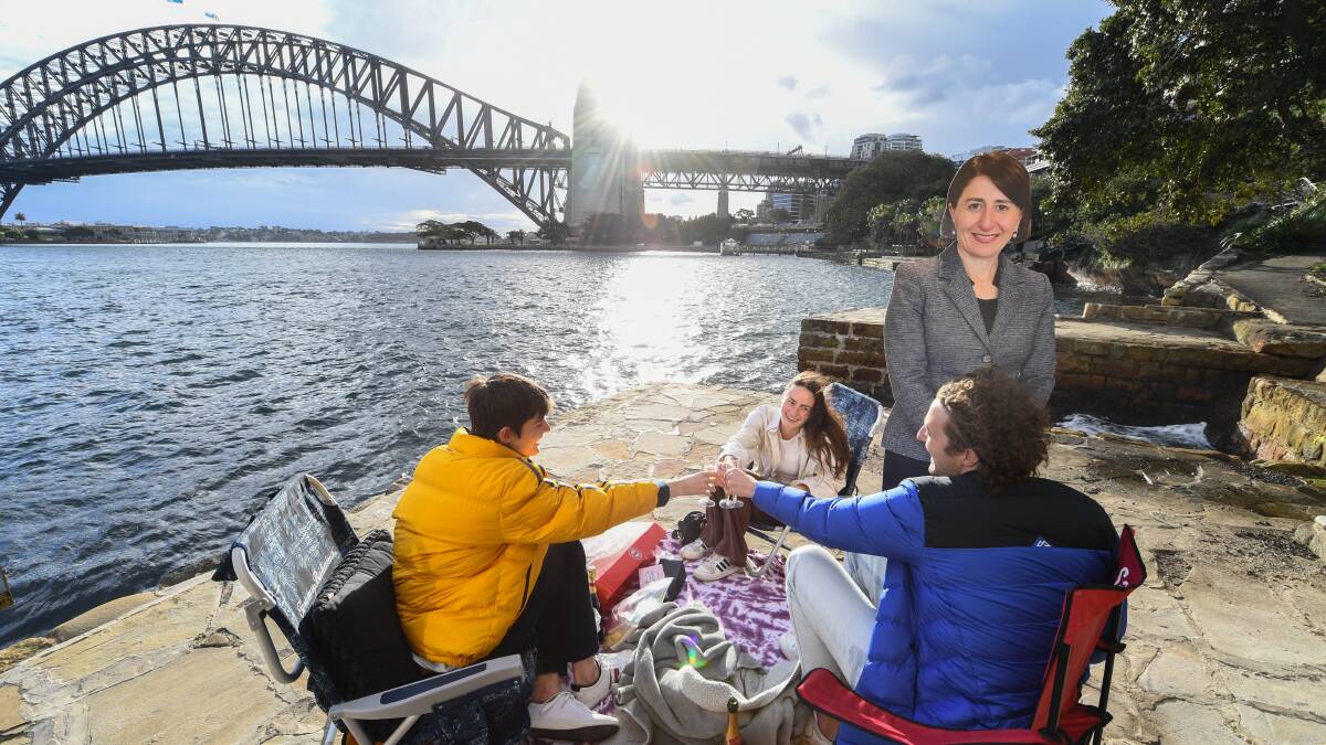 Patrick Slocombe, Max Mazaraki and Rosie O'Shea gather together in Kirribilli for a picnic alongside a life-sized cardboard cutout of NSW Premier Gladys Berejiklian. Picture: Getty Images