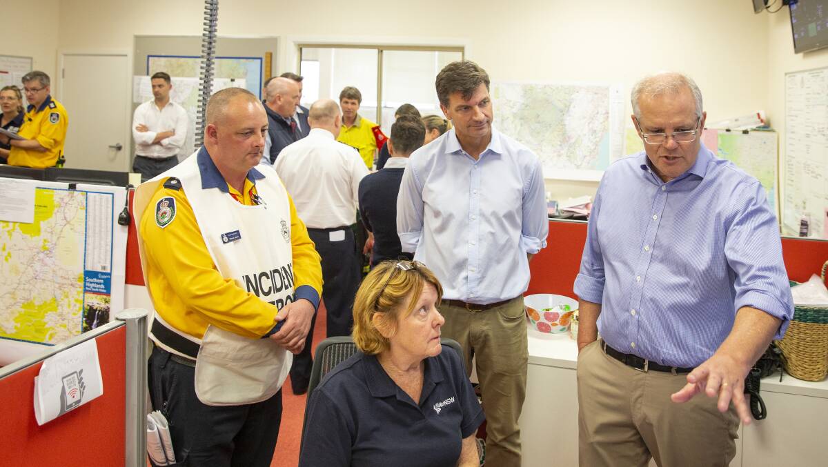 Prime Minister Scott Morrison talks to a volunteer at the Picton Evacuation Centre on Sunday. Picture: Getty Images