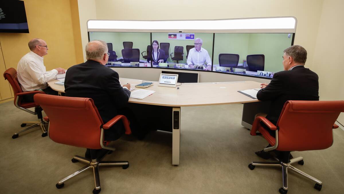Prime Minister Scott Morrison speaks with NSW Premier Gladys Berejiklian from the telepresence room at Parliament House. Picture: Getty Images