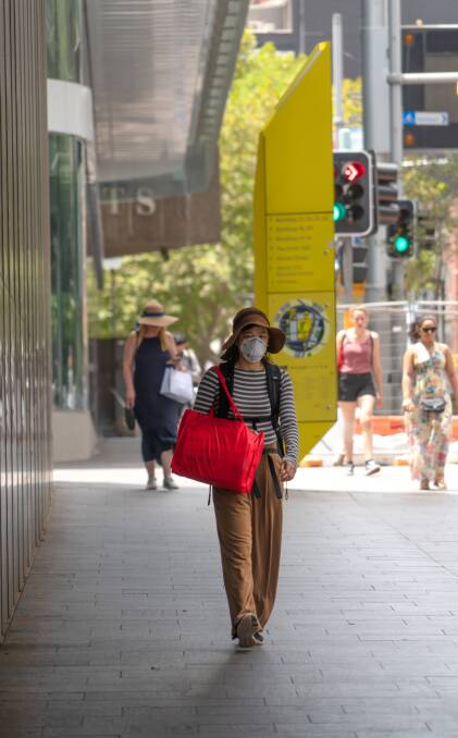 A woman wears a protective breathing mask to protect herself against the novel coronavirus in Sydney. Picture: Shutterstock