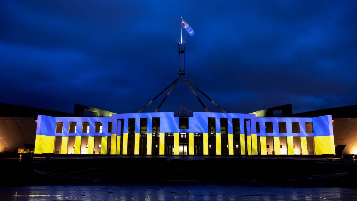 Australian Parliament House lit up in the colours of Ukraine's flag on Monday night. Picture: Sitthixay Ditthavong