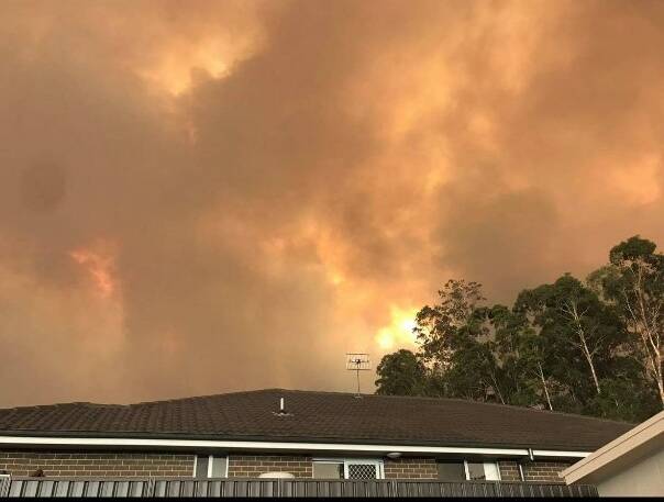 Fire looms in the background of Jenny Gould's parents' home in Sunshine Bay. Picture: Supplied