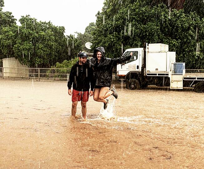 Jack Kidd and Katy Scott celebrate the rain at Tabletop Station, Croydon, in the wake of ex-tropical cyclone Imogen. Photo: Jane Kidd.