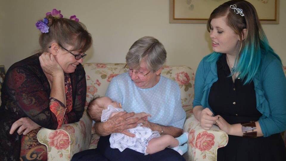 Nicola Fisher, left, died while in the care of Canberra Hospital. She is pictured with her mother Barbara Fisher holding Nicola's first grandchild Miyuki Smith, and Nicola's daughter and Miyuki's mother, Freyja Smith. 