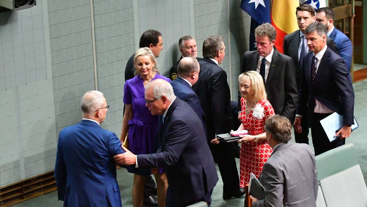 Coalition MPs show their support for Mr Morrison after his speech. Picture by Elesa Kurtz