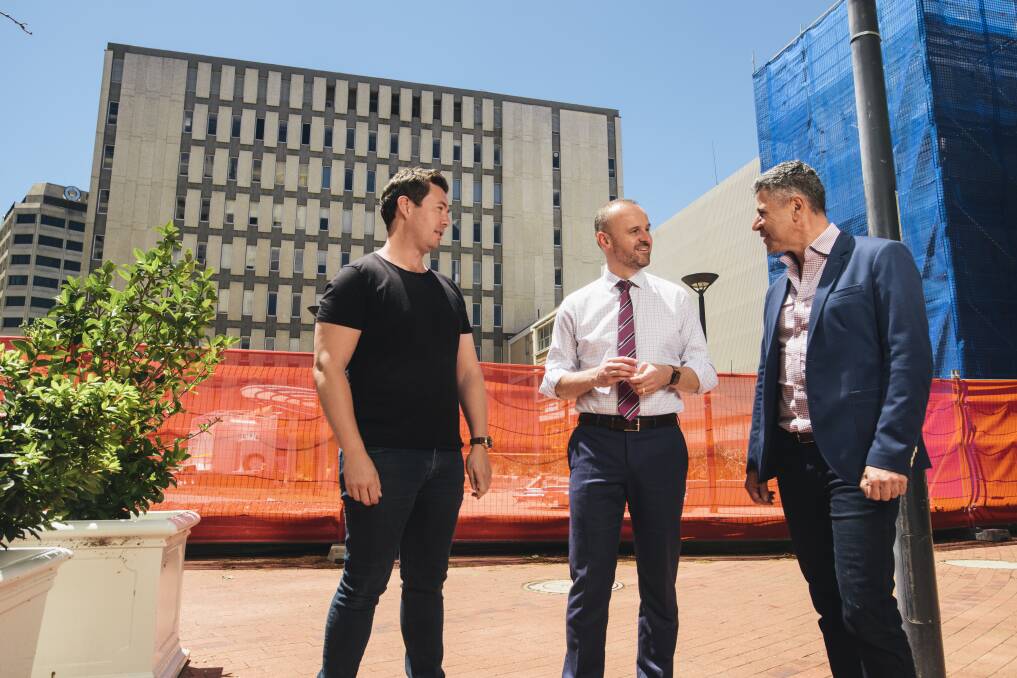 Crafted's Matt James, left, and Peter Sarris, right, discuss the new development with Chief Minister Andrew Barr onsite in 2017. Picture: Rohan Thomson
