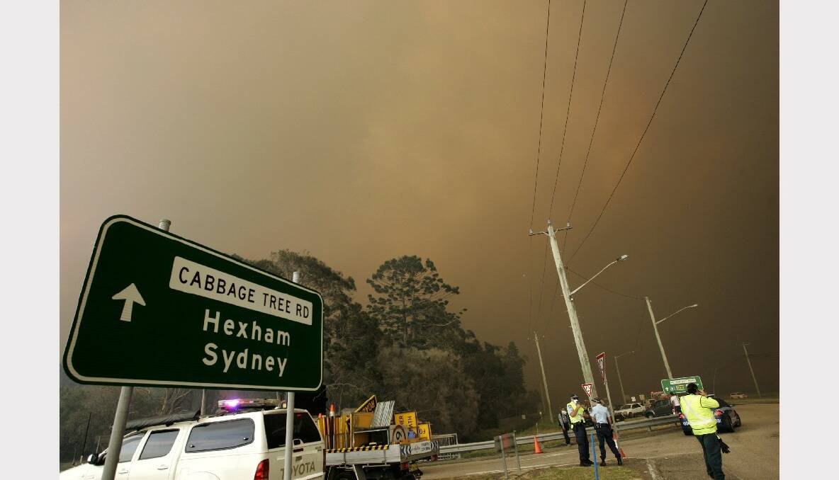 A fire has broken containment lines at Williamtown. Pictures taken from corner of Cabbage Tree Road and Nelson Bay Road. Photo: Jonathan Carroll, Newcastle Herald.