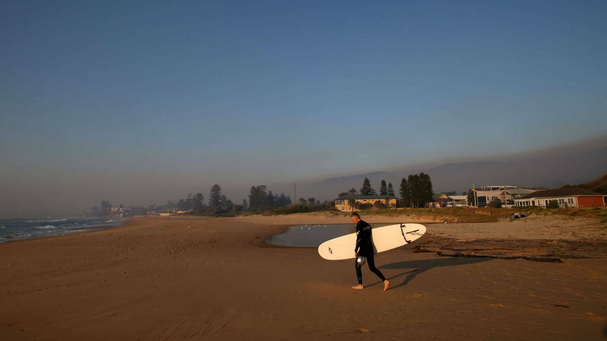 A surfer heads for the water on Thirroul beach. Picture: KIRK GILMOUR, Illawarra Mercury 