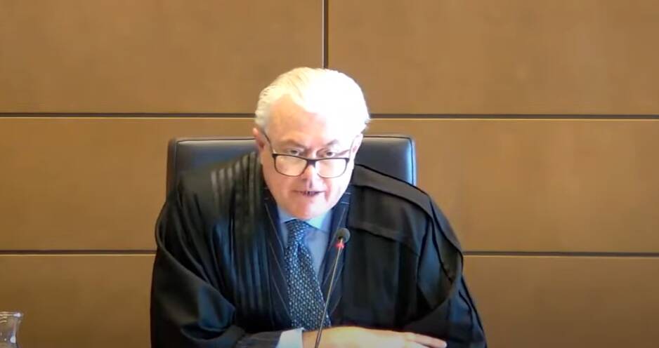 Justice Michael Lee reading his judgment on Monday. Picture screenshot