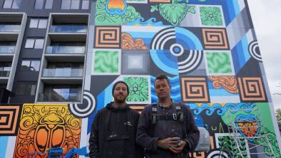 Artists Beastman (Brad Eastman) and Phibs (Tim de Haan) in front of their mural. Picture: Britt Nichols