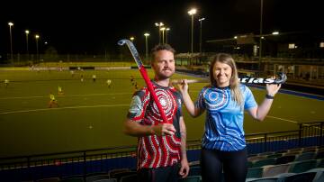 Garry Backhus and Emma Ronnfeldt wear the Indigenous jerseys for Hockey ACT's Reconciliation Round on Ngunnawal Country this weekend. Picture: Elesa Kurtz