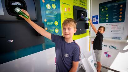 Brothers Blake, 10, and Charlie Cargill, 7, using Canberra's first reverse vending machine at the Erindale Shopping Centre. Picture: Elesa Kurtz