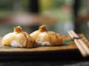 Hokkaido scallop nigiri with almond honey and lemon burm. Picture by Keegan Carroll