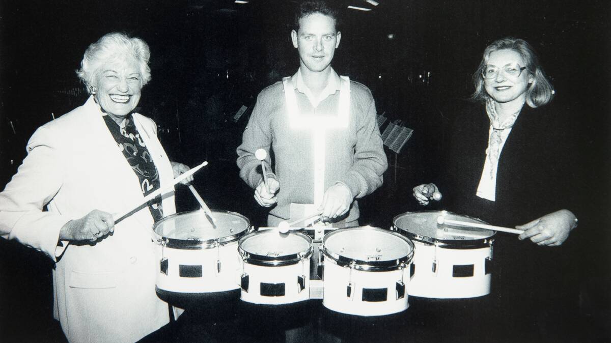 Elizabeth Grant and Cathy Winters beat the drums with Lance Corporal Neil Reeves of the RMC Duntroon band on August 24, 1996.