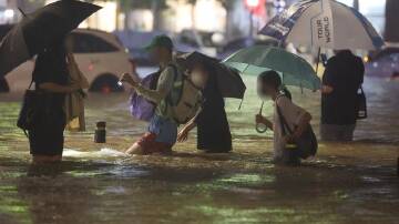 At least eight people are dead after the worst rains in Seoul, South Korea in years. (EPA PHOTO)